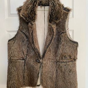 Reversible vest.  One side is Suede.  Brown/Black/Off White in color